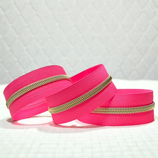 Hot Pink Nylon Zipper Tape with Gold Coil (Sold By the Yard)